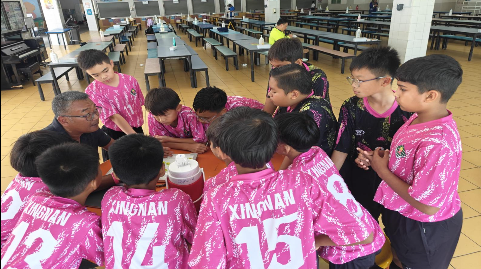 Listening to the game plan by the school coach.
